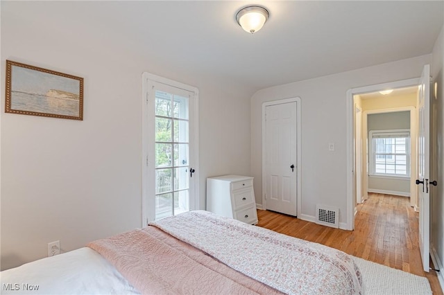 4206 Bushnell Rd, University Heights, OH 44118 - bedroom with light wood-type flooring, multiple windows, and baseboards
