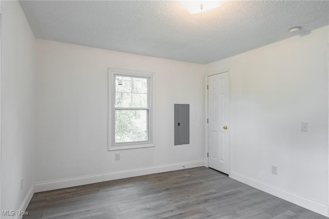 2403 45th St, Parkersburg, WV 26104 - empty room featuring electric panel, wood finished floors, a textured ceiling, and baseboards