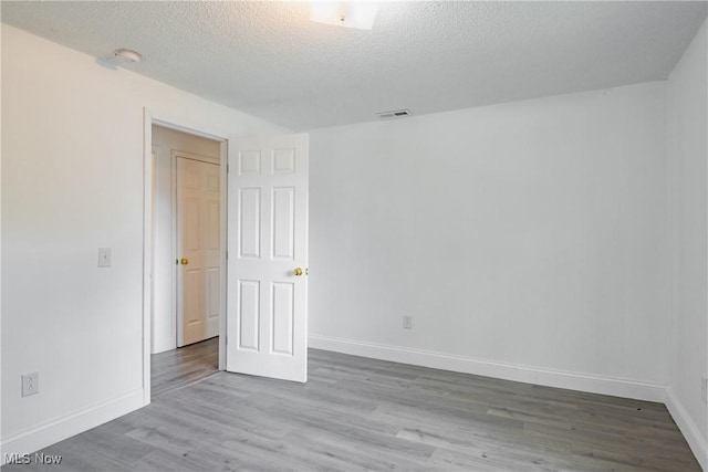 2403 45th St, Parkersburg, WV 26104 - empty room featuring wood finished floors, baseboards, a textured ceiling, and a smoke detector