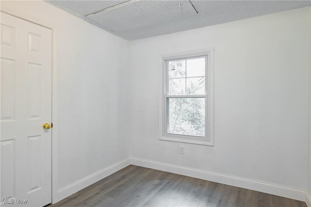2403 45th St, Parkersburg, WV 26104 - unfurnished room featuring dark wood-style flooring, baseboards, and a textured ceiling