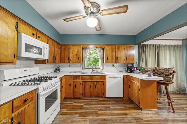 425 Warwick St, Akron, OH 44305 - kitchen with white appliances, a sink, a peninsula, brown cabinetry, and light countertops