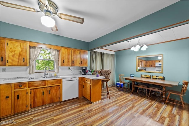 425 Warwick St, Akron, OH 44305 - kitchen with white appliances, a sink, brown cabinetry, light countertops, and a peninsula