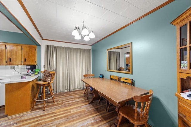 425 Warwick St, Akron, OH 44305 - dining space with ornamental molding, light wood-style flooring, and a chandelier