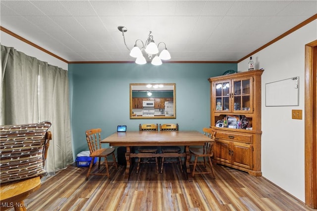 425 Warwick St, Akron, OH 44305 - dining area with ornamental molding, a chandelier, and wood finished floors