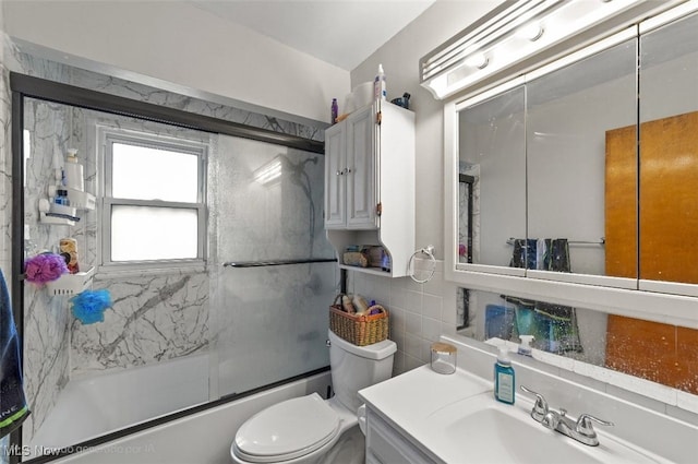 425 Warwick St, Akron, OH 44305 - full bathroom with combined bath / shower with glass door, vanity, toilet, and tile walls