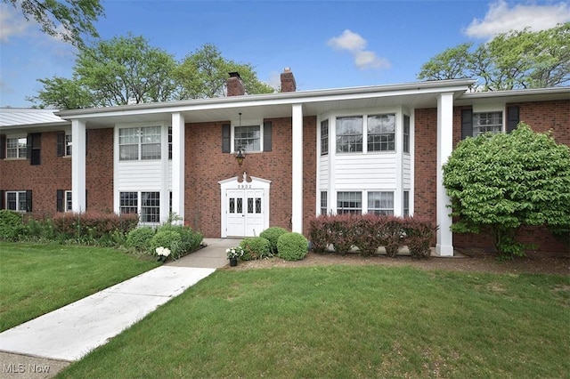 2932 Pease Dr Unit 210, Rocky River, OH 44116 - greek revival house featuring a chimney, a front lawn, and brick siding