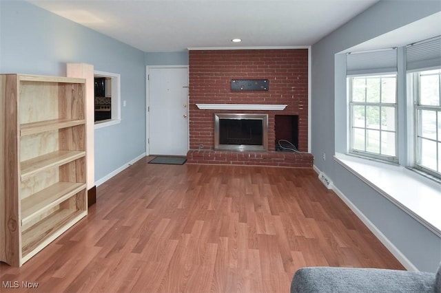 2932 Pease Dr Unit 210, Rocky River, OH 44116 - unfurnished living room with baseboards, wood finished floors, a brick fireplace, and recessed lighting