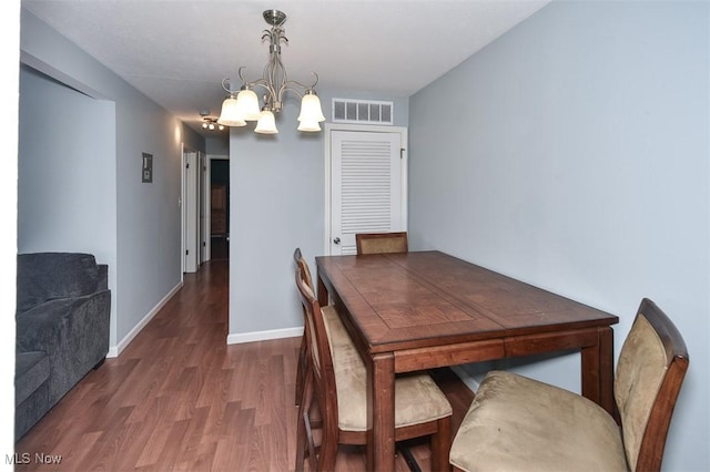 2932 Pease Dr Unit 210, Rocky River, OH 44116 - dining area featuring a chandelier, wood finished floors, and baseboards