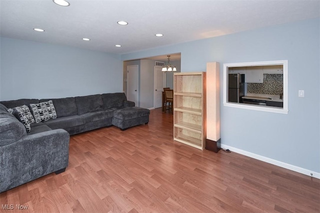 2932 Pease Dr Unit 210, Rocky River, OH 44116 - living room featuring a chandelier, wood finished floors, baseboards, and recessed lighting