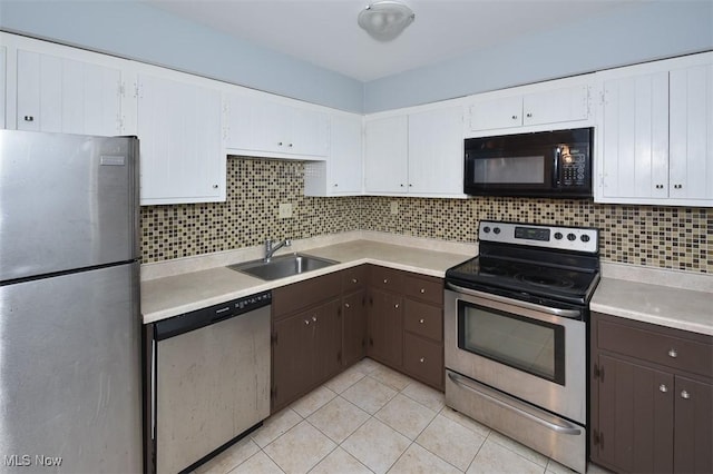 2932 Pease Dr Unit 210, Rocky River, OH 44116 - kitchen featuring appliances with stainless steel finishes, a sink, light countertops, dark brown cabinetry, and white cabinetry