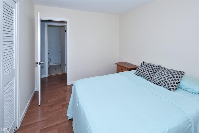 2932 Pease Dr Unit 210, Rocky River, OH 44116 - bedroom with dark wood-type flooring, a closet, and baseboards