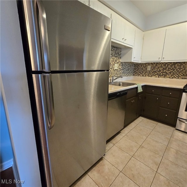 2932 Pease Dr Unit 210, Rocky River, OH 44116 - kitchen with stainless steel appliances, a sink, light countertops, tasteful backsplash, and white cabinetry