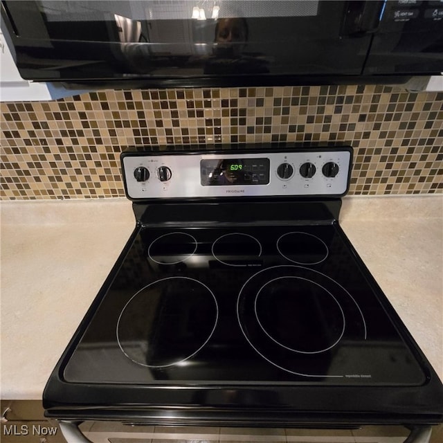 2932 Pease Dr Unit 210, Rocky River, OH 44116 - kitchen view of stainless steel electric range oven, tasteful backsplash, and light countertops
