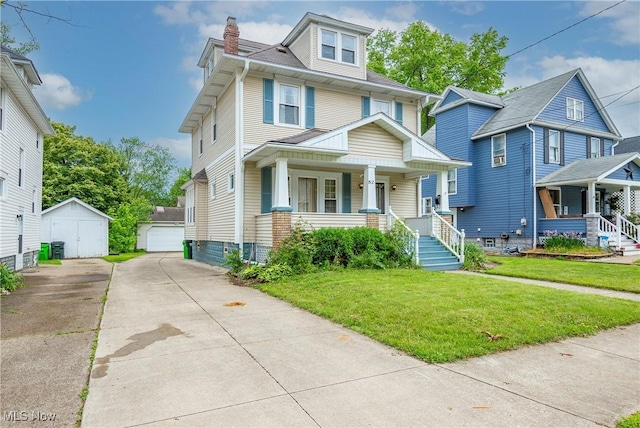 52 20th St SW, Barberton, OH 44203 - traditional style home featuring a porch, an outdoor structure, a detached garage, and a front lawn