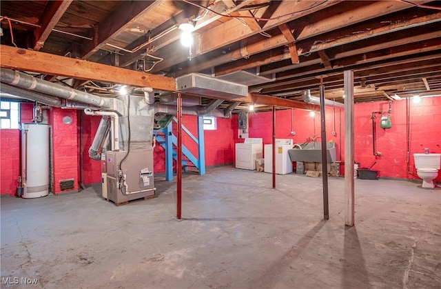 52 20th St SW, Barberton, OH 44203 - basement with water heater, washing machine and clothes dryer, heating unit, gas meter, and a sink