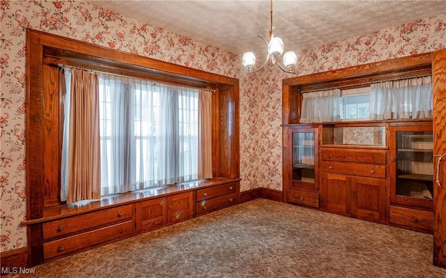 52 20th St SW, Barberton, OH 44203 - carpeted spare room featuring wallpapered walls, a chandelier, baseboards, and a textured ceiling