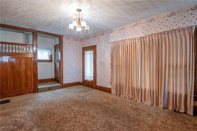 52 20th St SW, Barberton, OH 44203 - carpeted spare room with wallpapered walls, a chandelier, and a textured ceiling