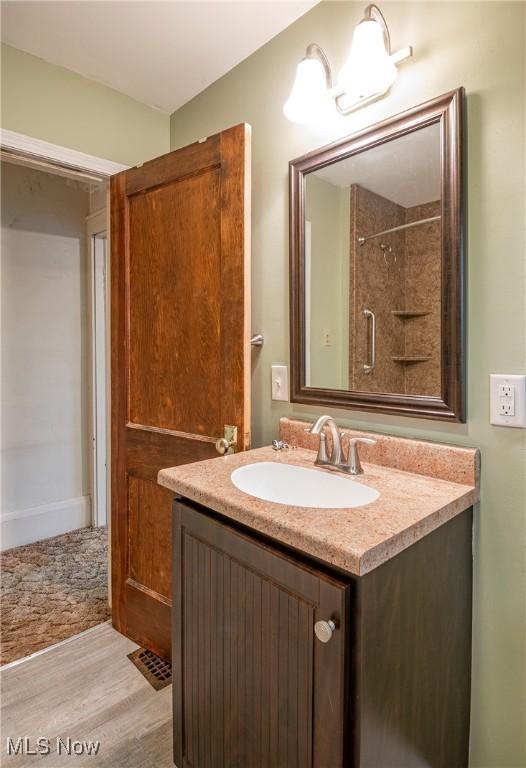 52 20th St SW, Barberton, OH 44203 - full bathroom with wood finished floors and vanity