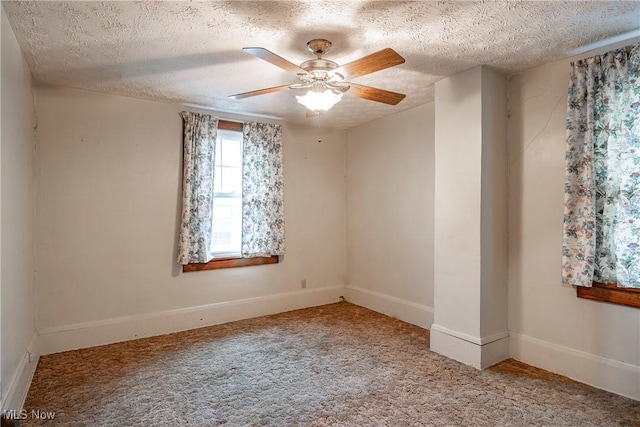 52 20th St SW, Barberton, OH 44203 - spare room with a textured ceiling, carpet flooring, ceiling fan, and baseboards