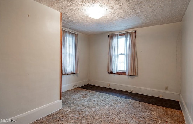 52 20th St SW, Barberton, OH 44203 - unfurnished room featuring a textured ceiling, baseboards, and wood finished floors