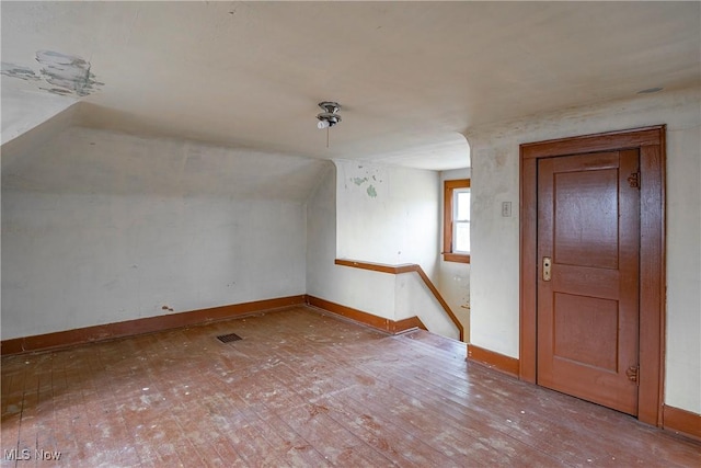 52 20th St SW, Barberton, OH 44203 - bonus room with baseboards, vaulted ceiling, and hardwood / wood-style flooring