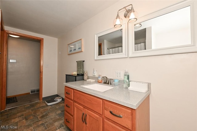 123 Wabash Ave, Orrville, OH 44667 - full bathroom with stone finish flooring, vanity, and baseboards