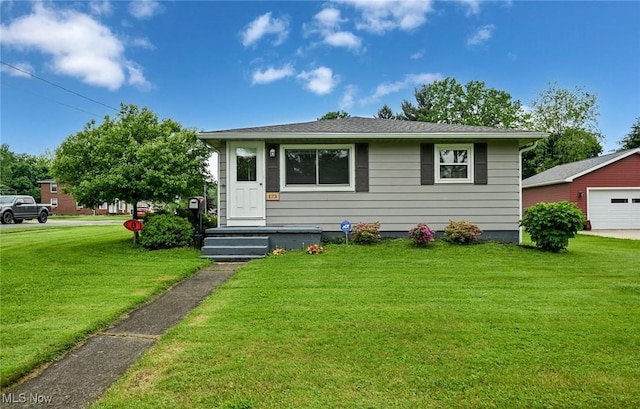 123 Wabash Ave, Orrville, OH 44667 - bungalow-style home with a front yard and a detached garage