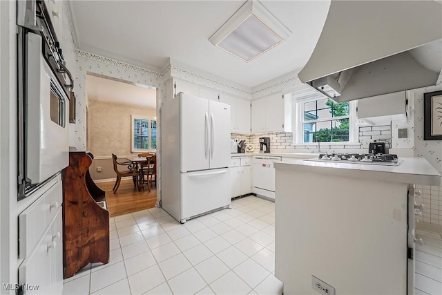 20110 Carolyn Ave, Rocky River, OH 44116 - kitchen featuring white appliances, range hood, a peninsula, and light countertops