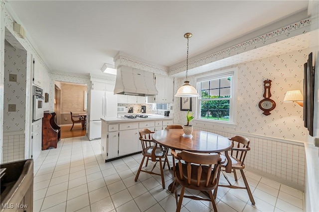 20110 Carolyn Ave, Rocky River, OH 44116 - dining area featuring wallpapered walls, light tile patterned floors, and wainscoting