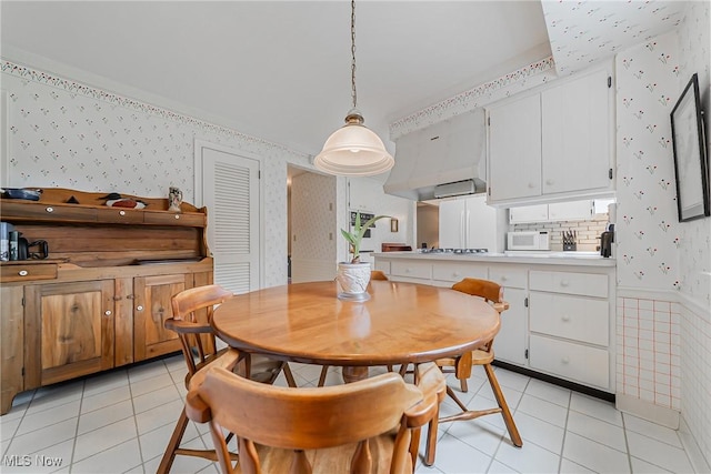 20110 Carolyn Ave, Rocky River, OH 44116 - dining room featuring wallpapered walls, light tile patterned flooring, and wainscoting