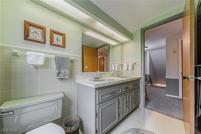 20110 Carolyn Ave, Rocky River, OH 44116 - full bath featuring double vanity, toilet, tile patterned flooring, and wainscoting