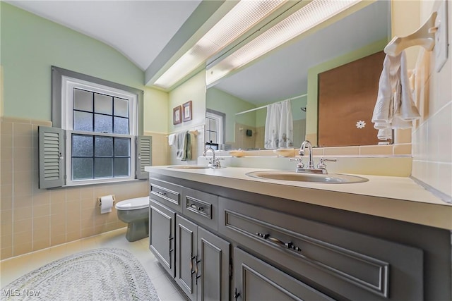 20110 Carolyn Ave, Rocky River, OH 44116 - full bath featuring double vanity, tile walls, toilet, a shower with curtain, and tile patterned floors