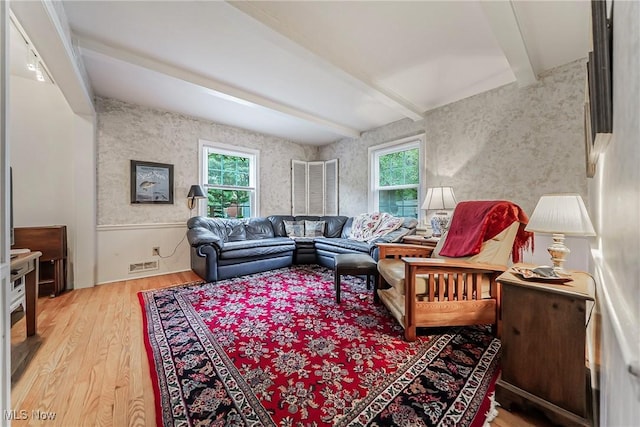 20110 Carolyn Ave, Rocky River, OH 44116 - living area featuring plenty of natural light, beamed ceiling, light wood-style floors, wallpapered walls, and wainscoting