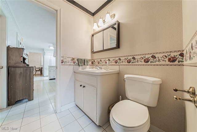 20110 Carolyn Ave, Rocky River, OH 44116 - bathroom with vanity, tile patterned flooring, toilet, wainscoting, and crown molding
