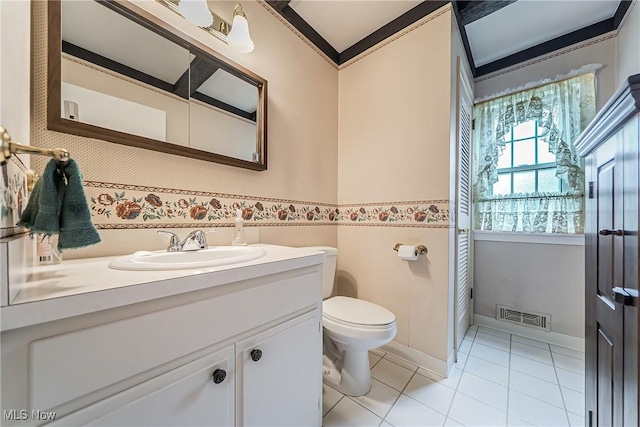 20110 Carolyn Ave, Rocky River, OH 44116 - bathroom with vanity, toilet, tile patterned floors, ornamental molding, and a wainscoted wall
