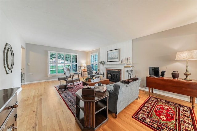 20110 Carolyn Ave, Rocky River, OH 44116 - living area featuring light wood finished floors, a fireplace, a desk, and baseboards