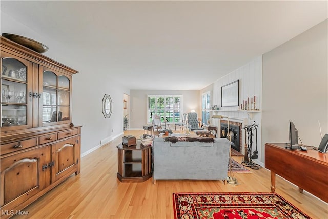 20110 Carolyn Ave, Rocky River, OH 44116 - living area featuring light wood-style floors, a brick fireplace, and baseboards