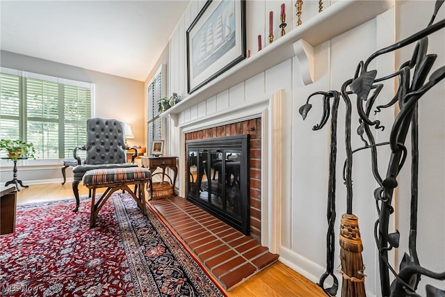 20110 Carolyn Ave, Rocky River, OH 44116 - sitting room featuring a brick fireplace, wood finished floors, and baseboards