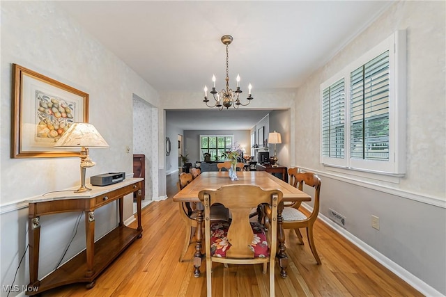 20110 Carolyn Ave, Rocky River, OH 44116 - dining room with a chandelier, light wood-style floors, and baseboards