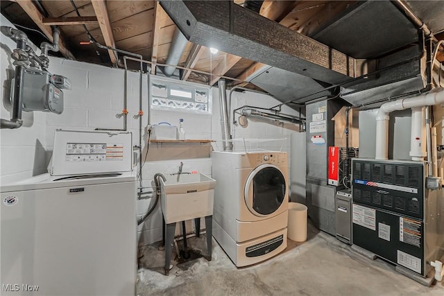 20110 Carolyn Ave, Rocky River, OH 44116 - laundry room featuring independent washer and dryer, heating unit, and concrete block wall