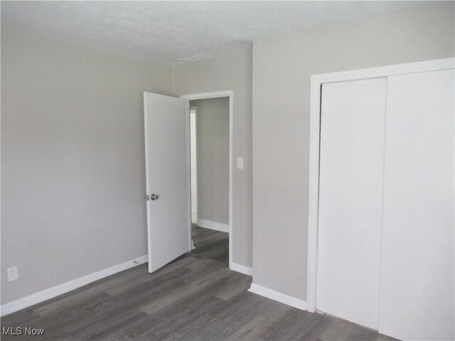 6453 Poplar Dr, Independence, OH 44131 - unfurnished bedroom featuring wood finished floors, baseboards, and a closet