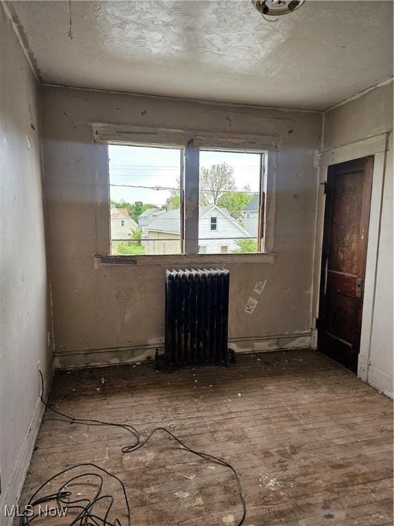 3474 W 60th St, Cleveland, OH 44102 - spare room featuring radiator and wood-type flooring