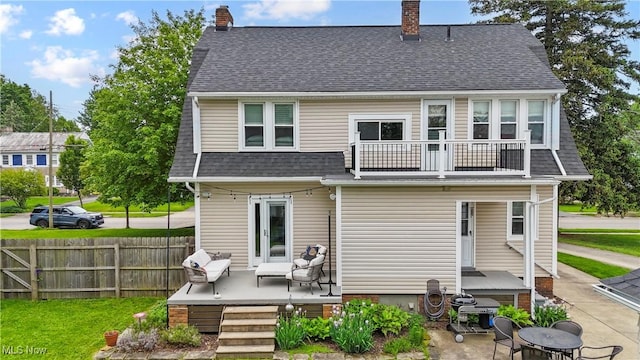 70 Samaritan Ave, Ashland, OH 44805 - rear view of property with a balcony, a chimney, a shingled roof, and a wooden deck