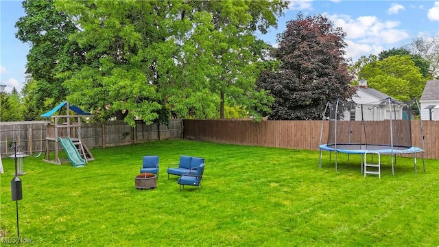 70 Samaritan Ave, Ashland, OH 44805 - view of yard featuring a trampoline, a playground, and an outdoor fire pit