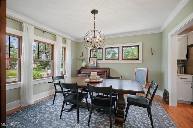 70 Samaritan Ave, Ashland, OH 44805 - dining space with a chandelier, crown molding, wood finished floors, and baseboards