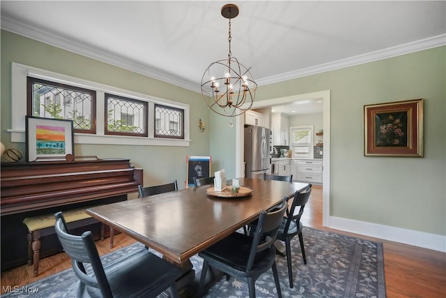 70 Samaritan Ave, Ashland, OH 44805 - dining area featuring crown molding, a chandelier, wood finished floors, and baseboards