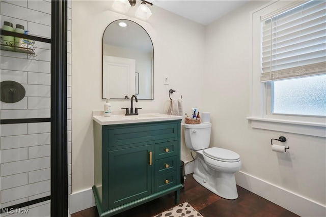 70 Samaritan Ave, Ashland, OH 44805 - full bath with toilet, baseboards, wood finished floors, vanity, and a shower