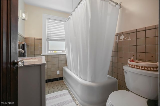 70 Samaritan Ave, Ashland, OH 44805 - bathroom with tile walls, tile patterned flooring, toilet, vanity, and shower / bath combo with shower curtain