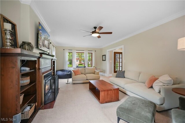 70 Samaritan Ave, Ashland, OH 44805 - living room with a glass covered fireplace, ceiling fan, crown molding, and light colored carpet