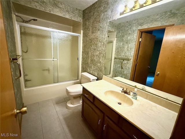 305 Flintwood Dr, Marietta, OH 45750 - bathroom with tile patterned floors, vanity, toilet, and combined bath / shower with glass door